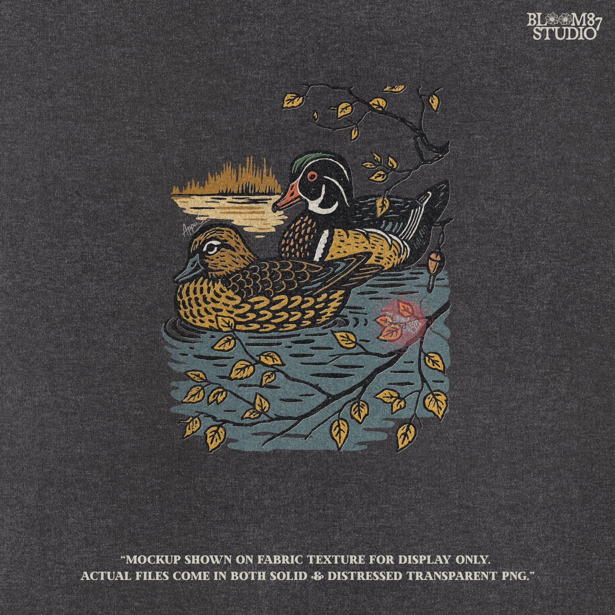 Vintage illustration of a wood duck couple floating on a pond, surrounded by fall leaves and branches, ideal for rustic nature sublimation.

Distressed Version:
Distressed wood duck pair in a peaceful pond setting with autumn leaves, perfect for farmhouse wildlife crafts and romantic outdoor art.