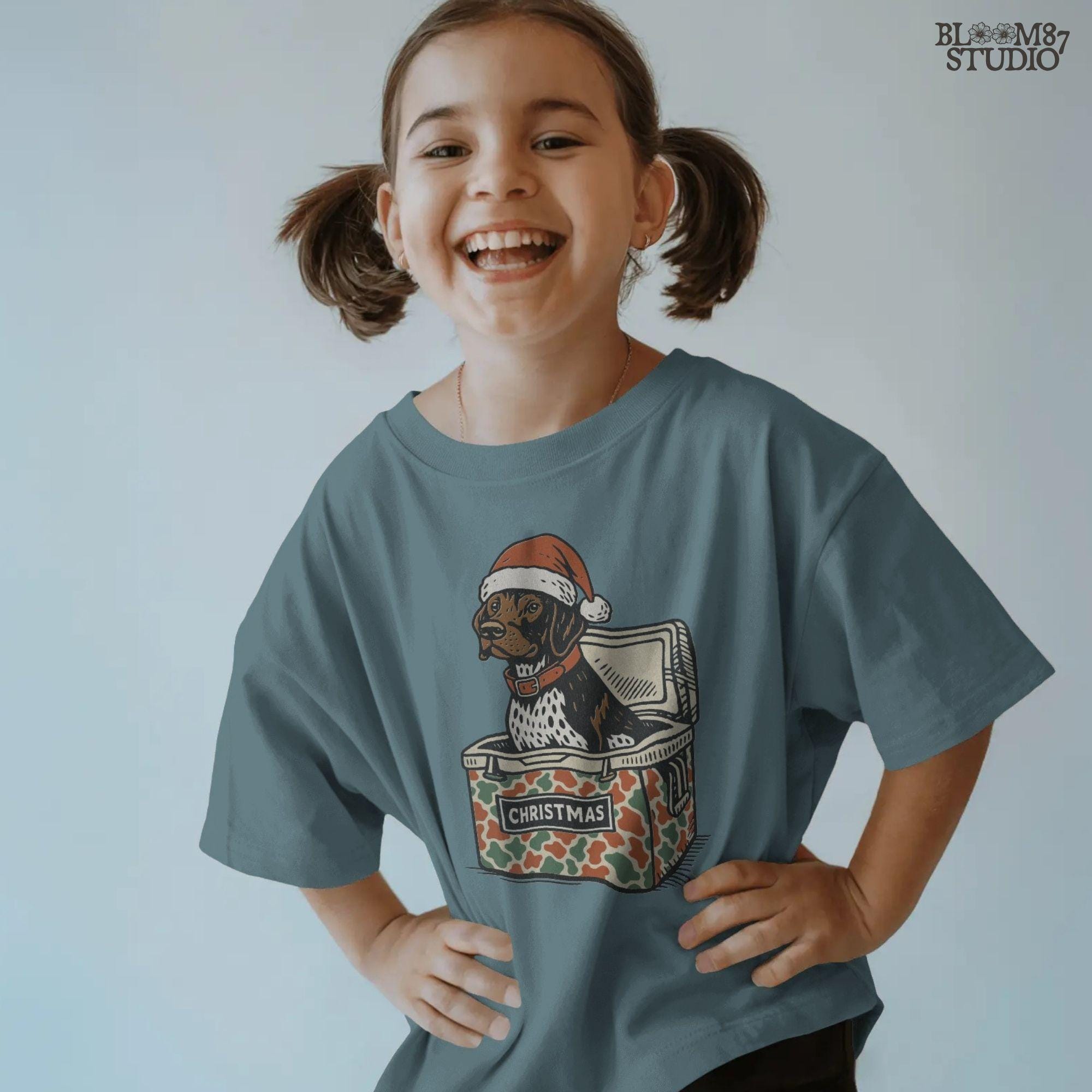 Solid Version:
Vintage illustration of a dog in a Santa hat sitting inside a camo-patterned Christmas cooler, sublimation PNG for rustic holiday crafts and pet decor.

Distressed Version:
Distressed artwork of a Christmas dog in camo cooler with Santa hat, funny sublimation PNG perfect for farmhouse festive shirts, mugs, and seasonal gifts.