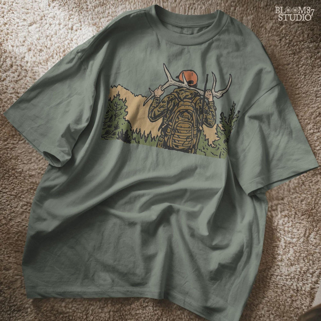 Solid version:
“Hunter carrying deer antlers on shoulders with backpack and rifle in forest – rustic hunting sublimation PNG for outdoor crafts”

Distressed version:
“Vintage distressed hunting sublimation PNG of hunter in camo with backpack and rifle carrying antlers in forest”