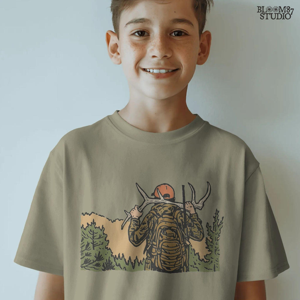 Solid version:
“Hunter carrying deer antlers on shoulders with backpack and rifle in forest – rustic hunting sublimation PNG for outdoor crafts”

Distressed version:
“Vintage distressed hunting sublimation PNG of hunter in camo with backpack and rifle carrying antlers in forest”