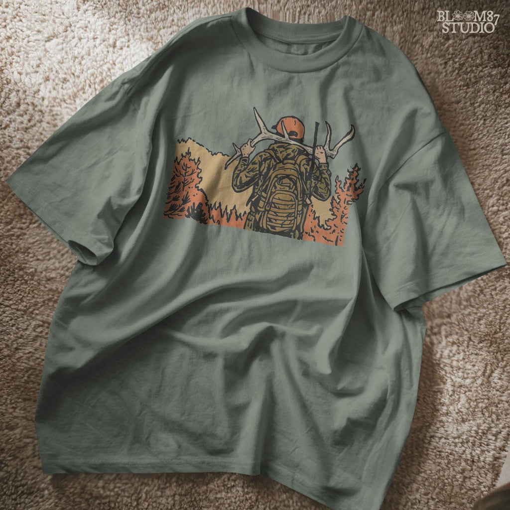 Solid version:
“Hunter carrying deer antlers with backpack in autumn forest – rustic hunting sublimation PNG for shirts and outdoor crafts”

Distressed version:
“Vintage distressed hunting sublimation PNG of hunter with antlers and backpack in autumn forest – rustic outdoor shirt design”