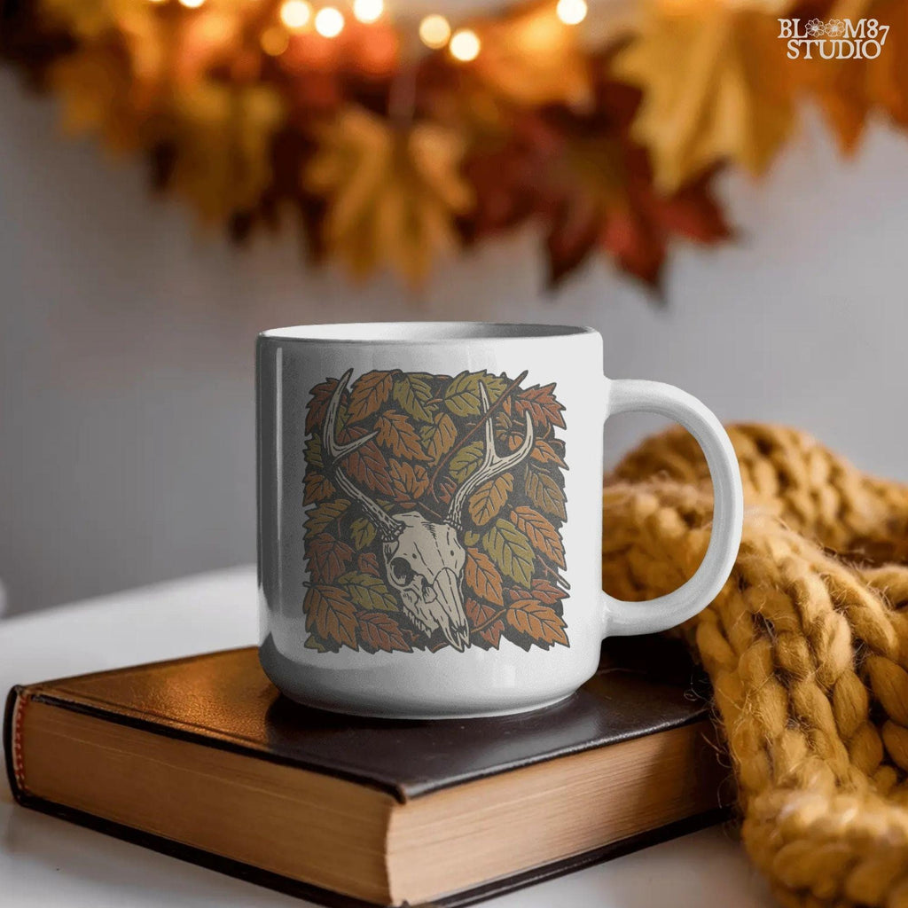 Deer skull with antlers surrounded by autumn leaves, rustic fall hunting sublimation PNG design.