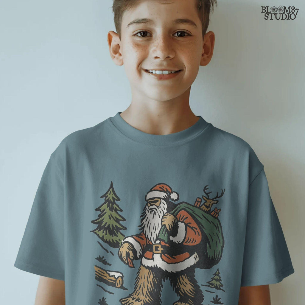 Solid version:
“Bigfoot dressed as Santa carrying green sack with reindeer and gifts in woodland scene – Christmas sublimation PNG for holiday crafts”

Distressed version:
“Vintage distressed sublimation PNG of Santa Bigfoot with sack of gifts and reindeer in rustic woodland scene – Christmas holiday shirt design”