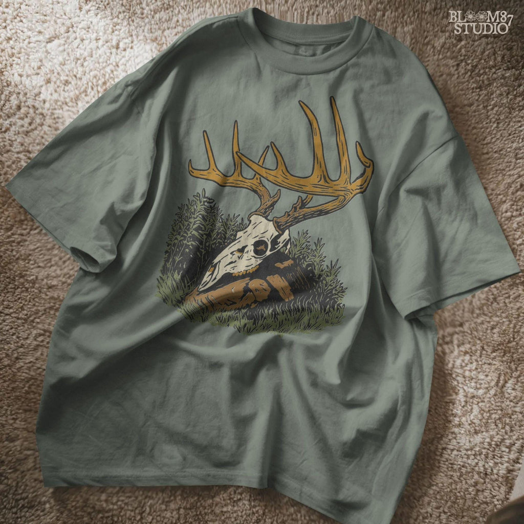 Solid version:
“Deer skull with large antlers resting in grass and rocks – rustic hunting sublimation PNG for crafts and lodge décor”

Distressed version:
“Vintage distressed sublimation PNG of deer skull with antlers in grass – rustic hunting and outdoor lodge shirt design”