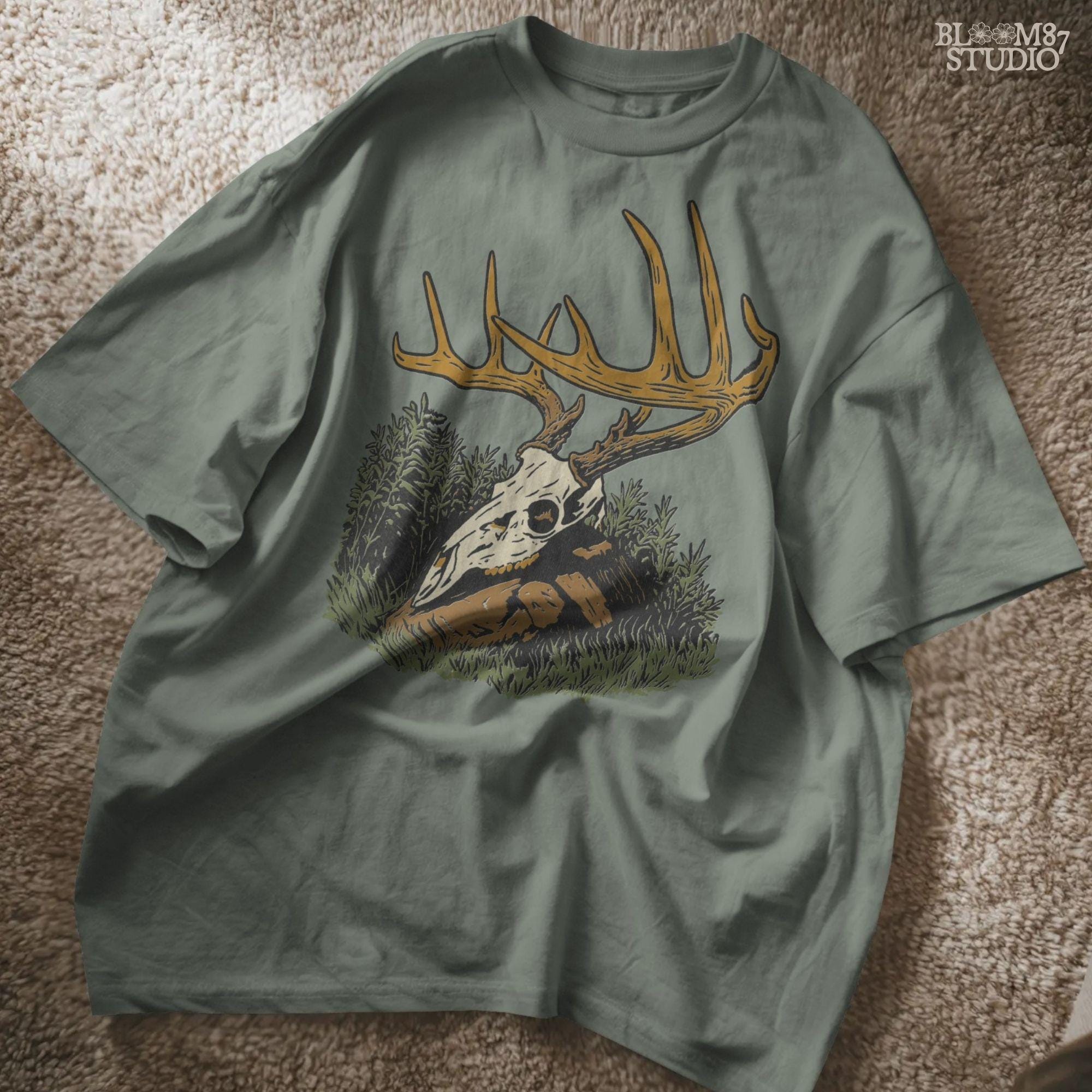 Solid version:
“Deer skull with large antlers resting in grass and rocks – rustic hunting sublimation PNG for crafts and lodge décor”

Distressed version:
“Vintage distressed sublimation PNG of deer skull with antlers in grass – rustic hunting and outdoor lodge shirt design”
