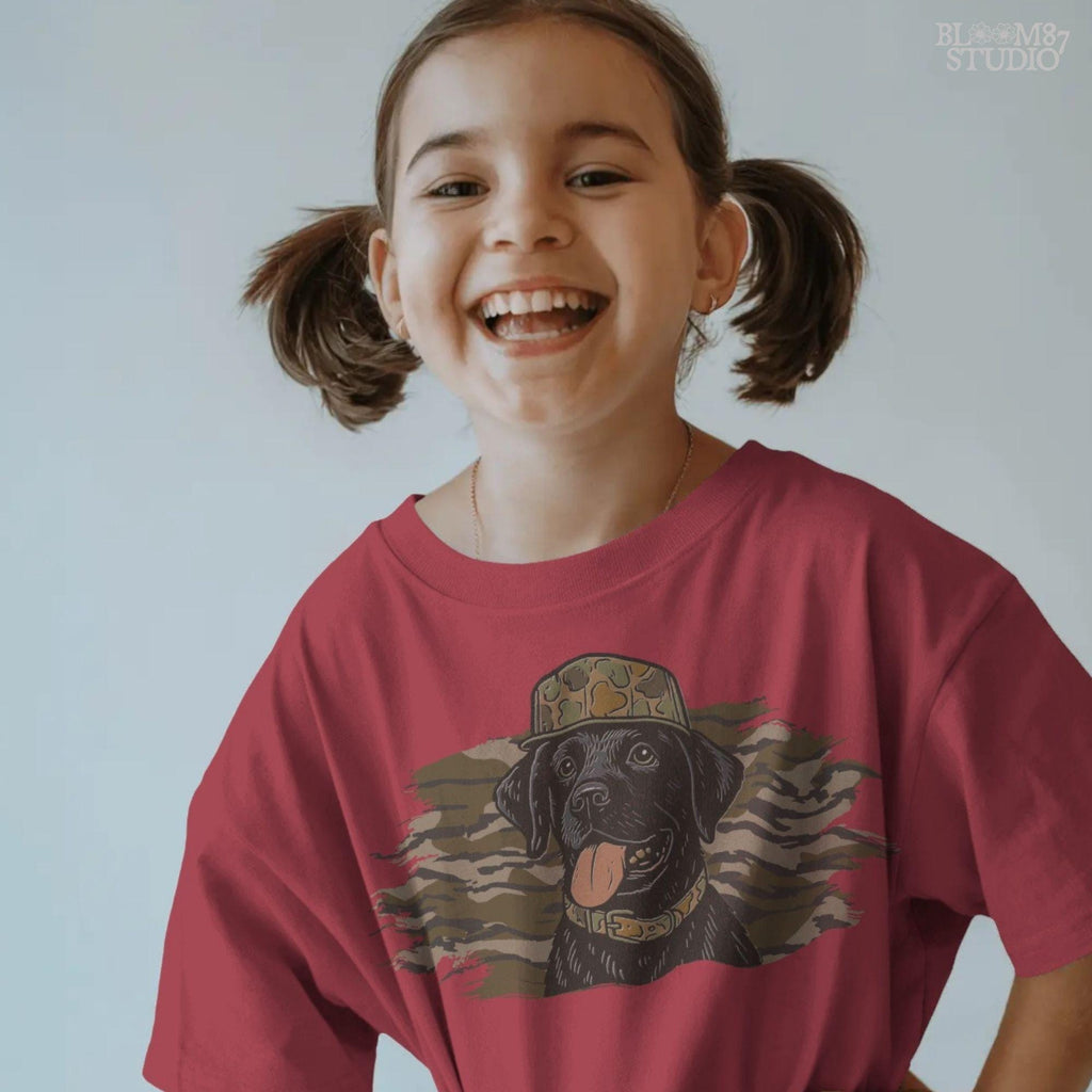 Solid version: Illustration of a black Labrador retriever wearing a camo hat and collar with camouflage background, hunting sublimation PNG.
Distressed version: Vintage distressed black lab with camo hat and collar against camo background, rustic hunting dog sublimation PNG.