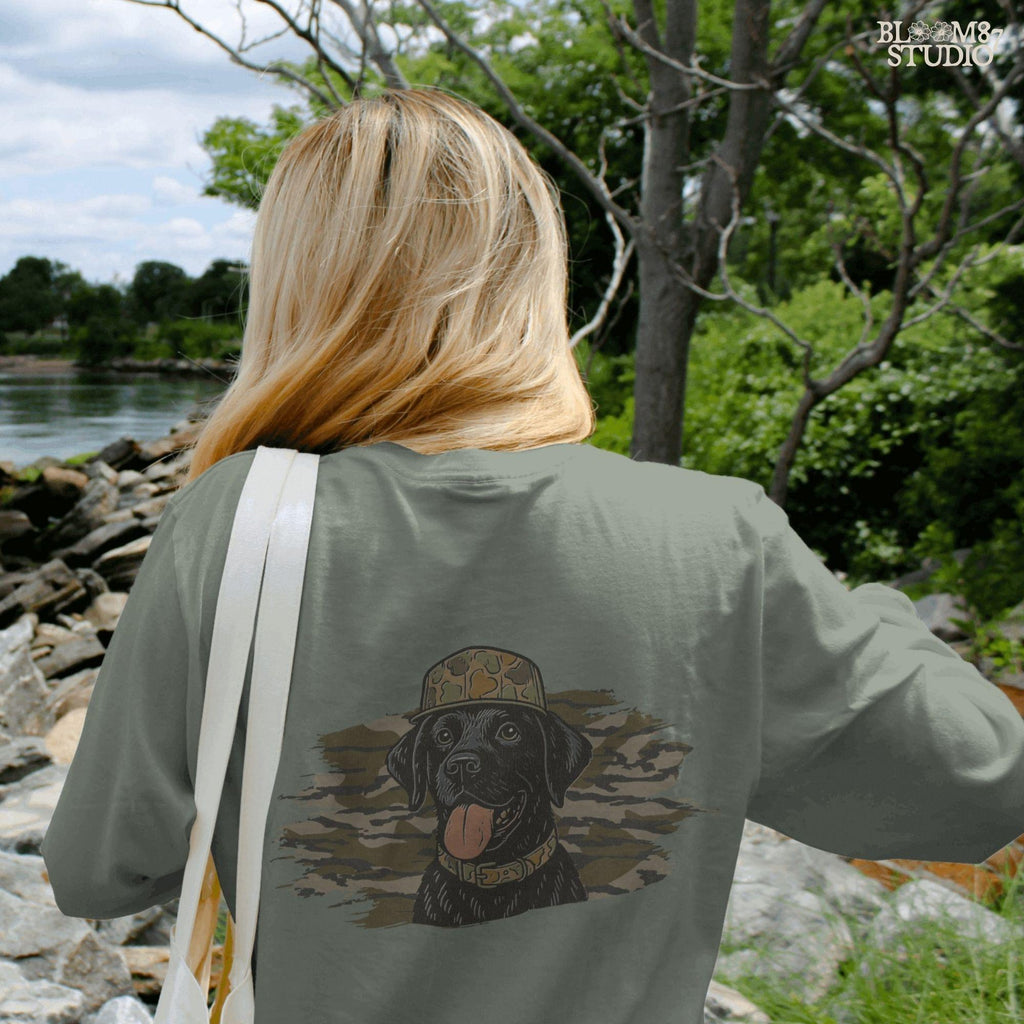 Solid version: Illustration of a black Labrador retriever wearing a camo hat and collar with camouflage background, hunting sublimation PNG.
Distressed version: Vintage distressed black lab with camo hat and collar against camo background, rustic hunting dog sublimation PNG.