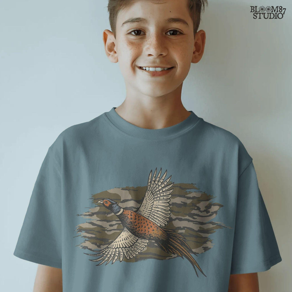 Solid version: Illustration of a flying pheasant with camouflage background, hunting sublimation PNG.
Distressed version: Vintage distressed pheasant in flight with camo backdrop, rustic hunting sublimation PNG.