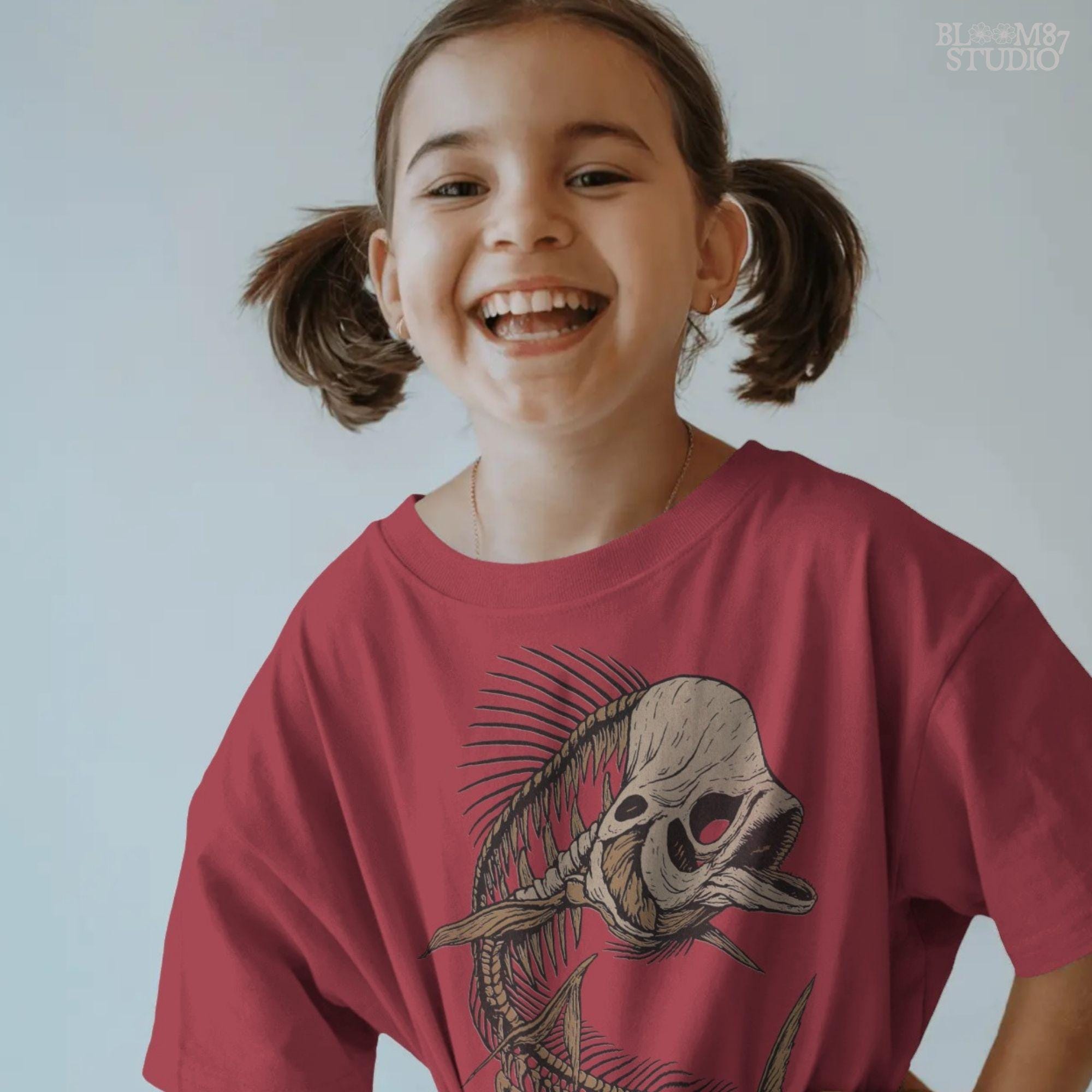 Solid version: Illustration of a spooky fish skeleton with skull head, Halloween creepy PNG design.
Distressed version: Vintage distressed skeleton fish with skull face and spiky bones, gothic Halloween PNG.