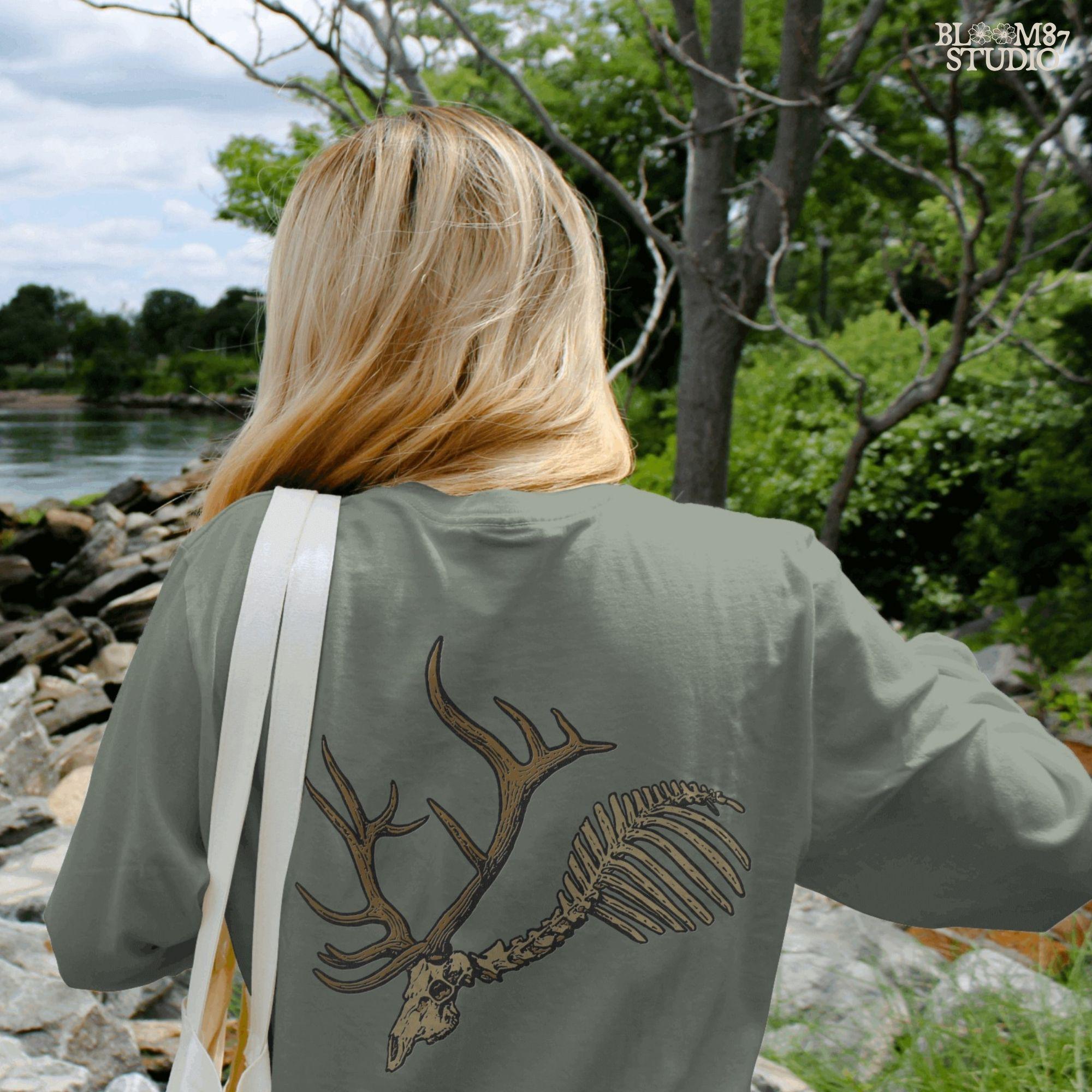 Solid version: Deer skull PNG with antlers and rib bones, spooky hunting skeleton design for Halloween.

Distressed version: Vintage deer skeleton PNG with antlers, rustic hunting and Halloween sublimation design.