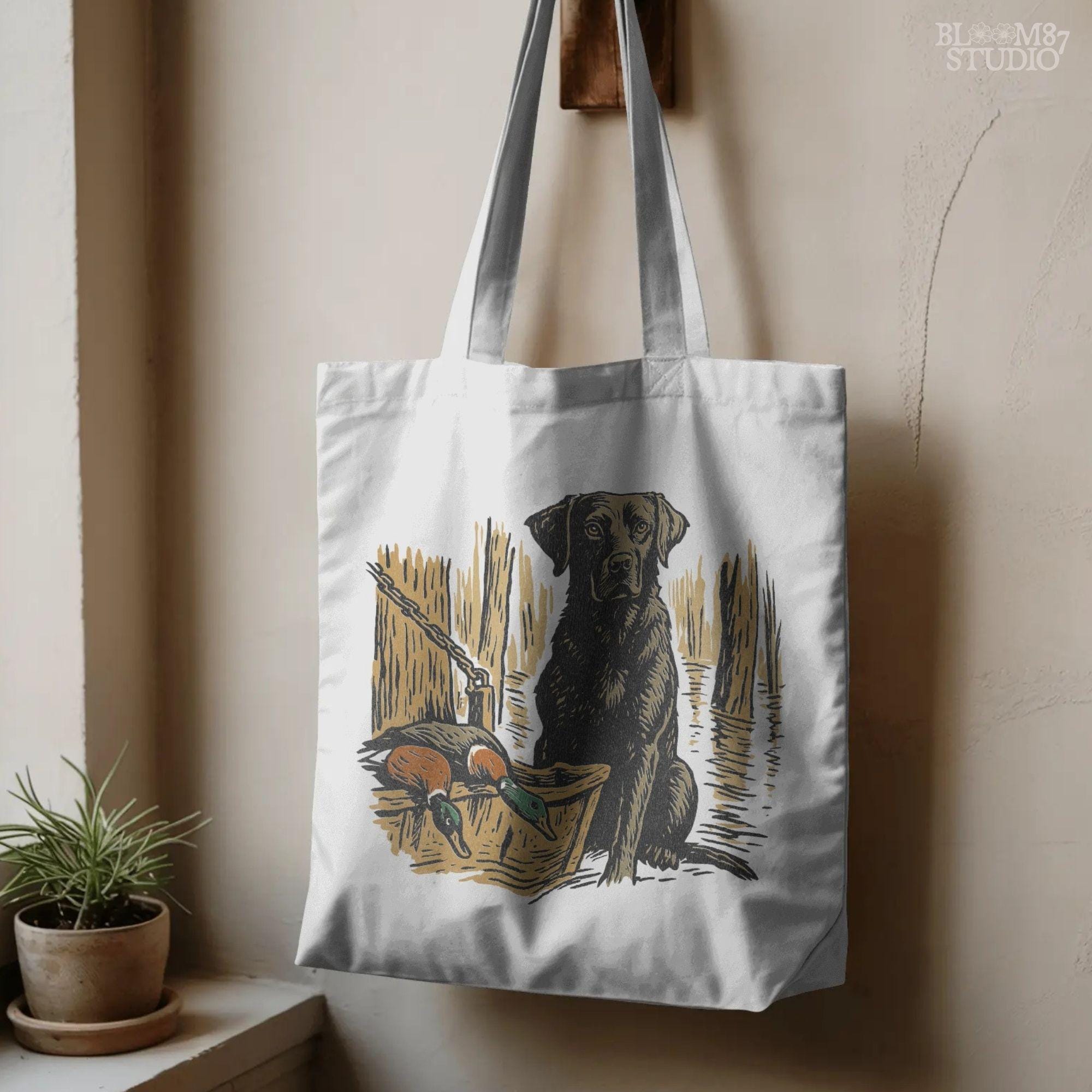 Illustration of a black Labrador retriever hunting dog in a marsh with mallard ducks in a wooden basket, sublimation PNG design.