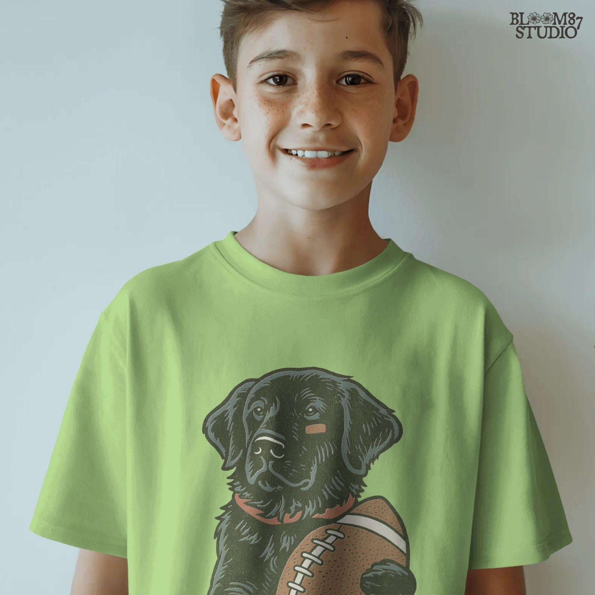 Illustration of a black Labrador Retriever holding a football, sublimation PNG design for game day and sports fan apparel.