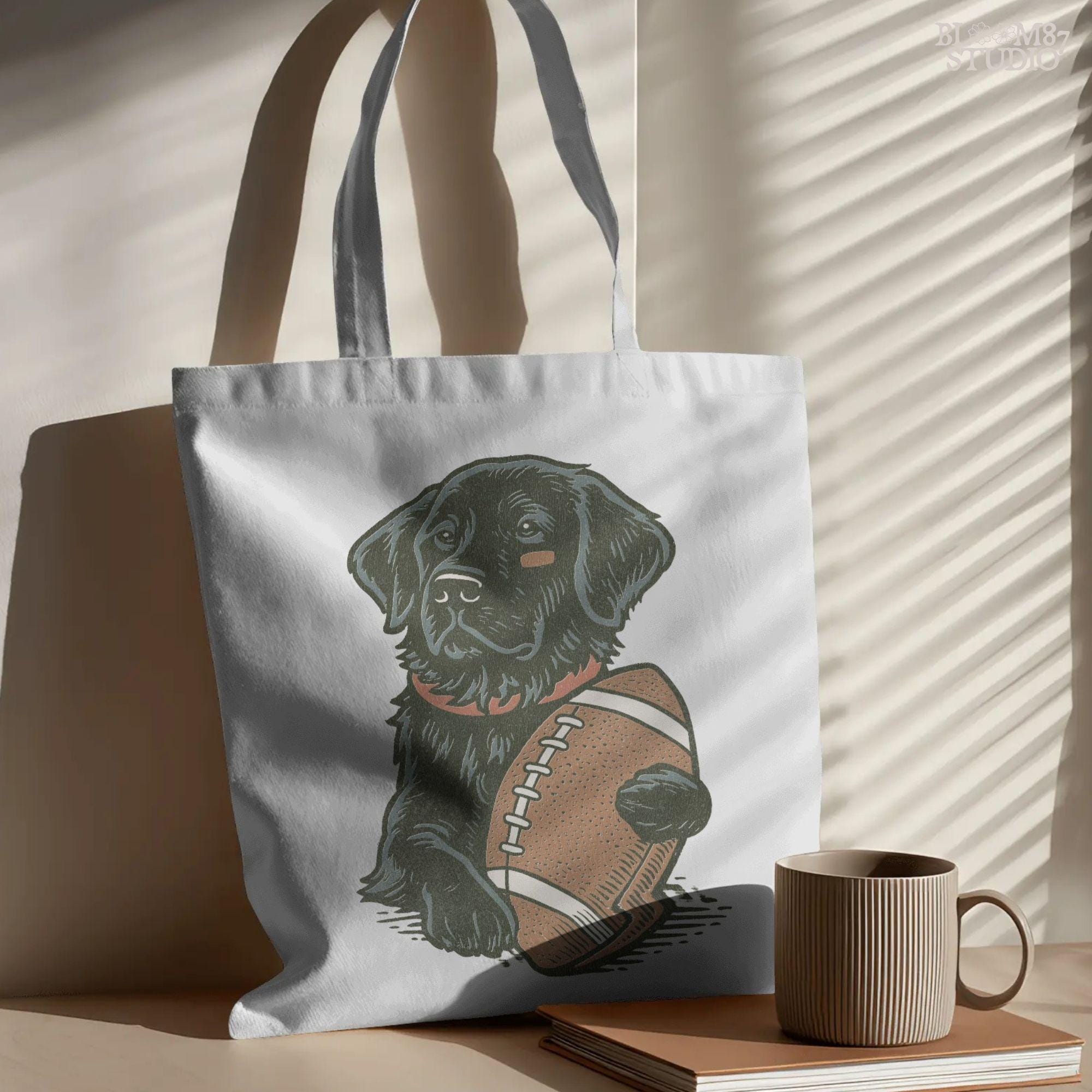 Illustration of a black Labrador Retriever holding a football, sublimation PNG design for game day and sports fan apparel.