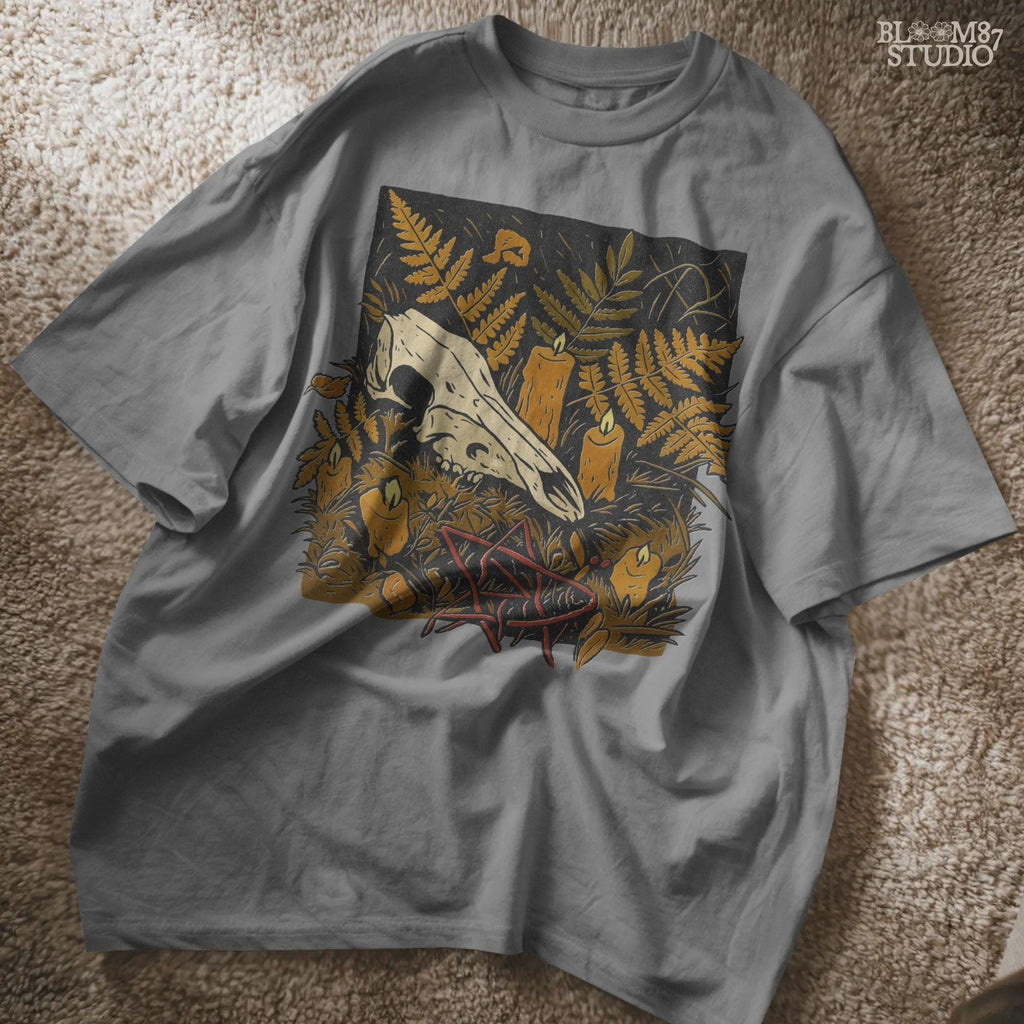 Deer skull surrounded by candles and ferns in a gothic Halloween forest scene, occult spooky sublimation PNG for shirts and decor.