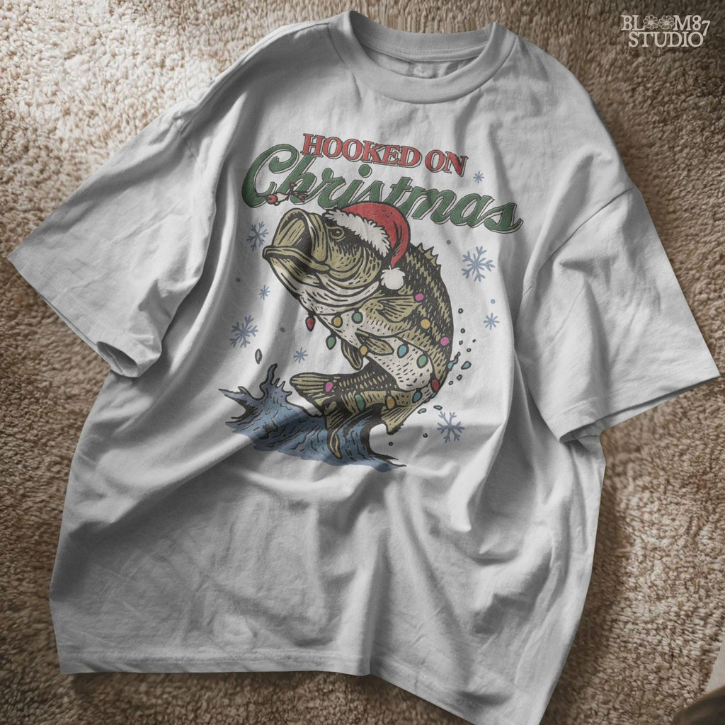 Holiday bass fishing PNG with Santa hat and winter theme, perfect for fishing lovers’ Christmas shirts and mugs.