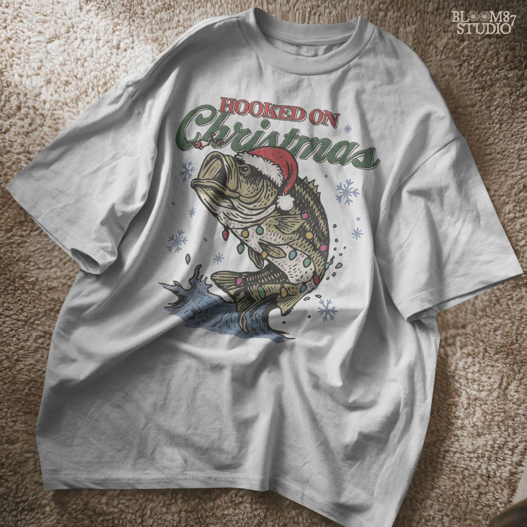 Holiday bass fishing PNG with Santa hat and winter theme, perfect for fishing lovers’ Christmas shirts and mugs.