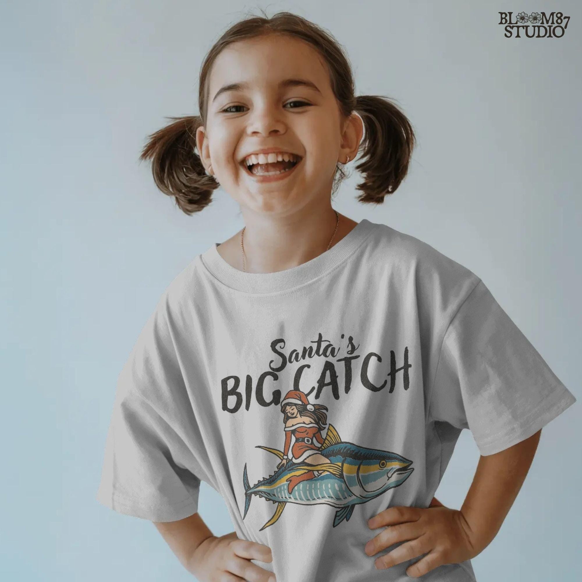 Festive Christmas fishing PNG artwork called Santa’s Big Catch. Features Santa girl on tuna fish for a humorous holiday fishing theme. Great for fisherman shirts, sweatshirts, mugs, and unique holiday gifts. Sublimation-ready PNG with transparent background allows versatile use in digital crafts, apparel design, and coastal decor.