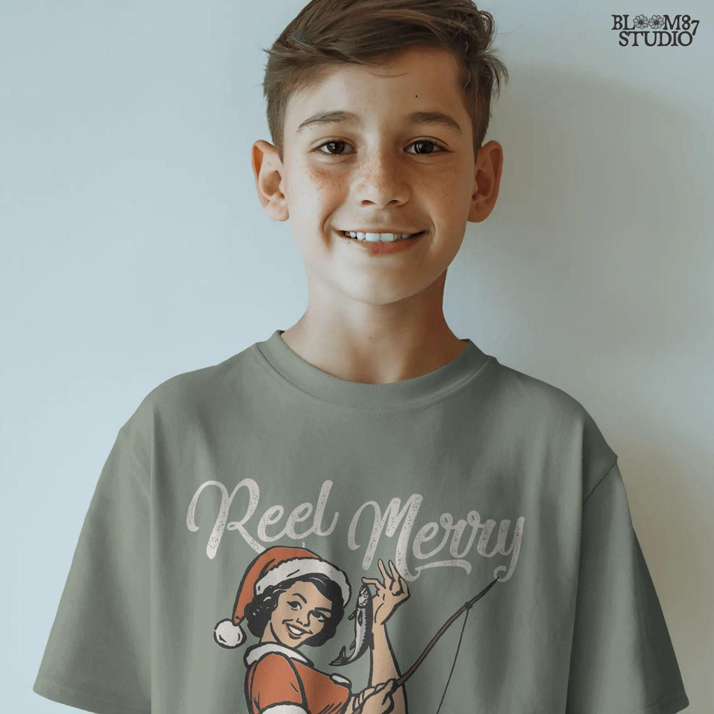 Retro-inspired Christmas PNG of a woman fishing in festive attire with a playful "Reel Merry" phrase.