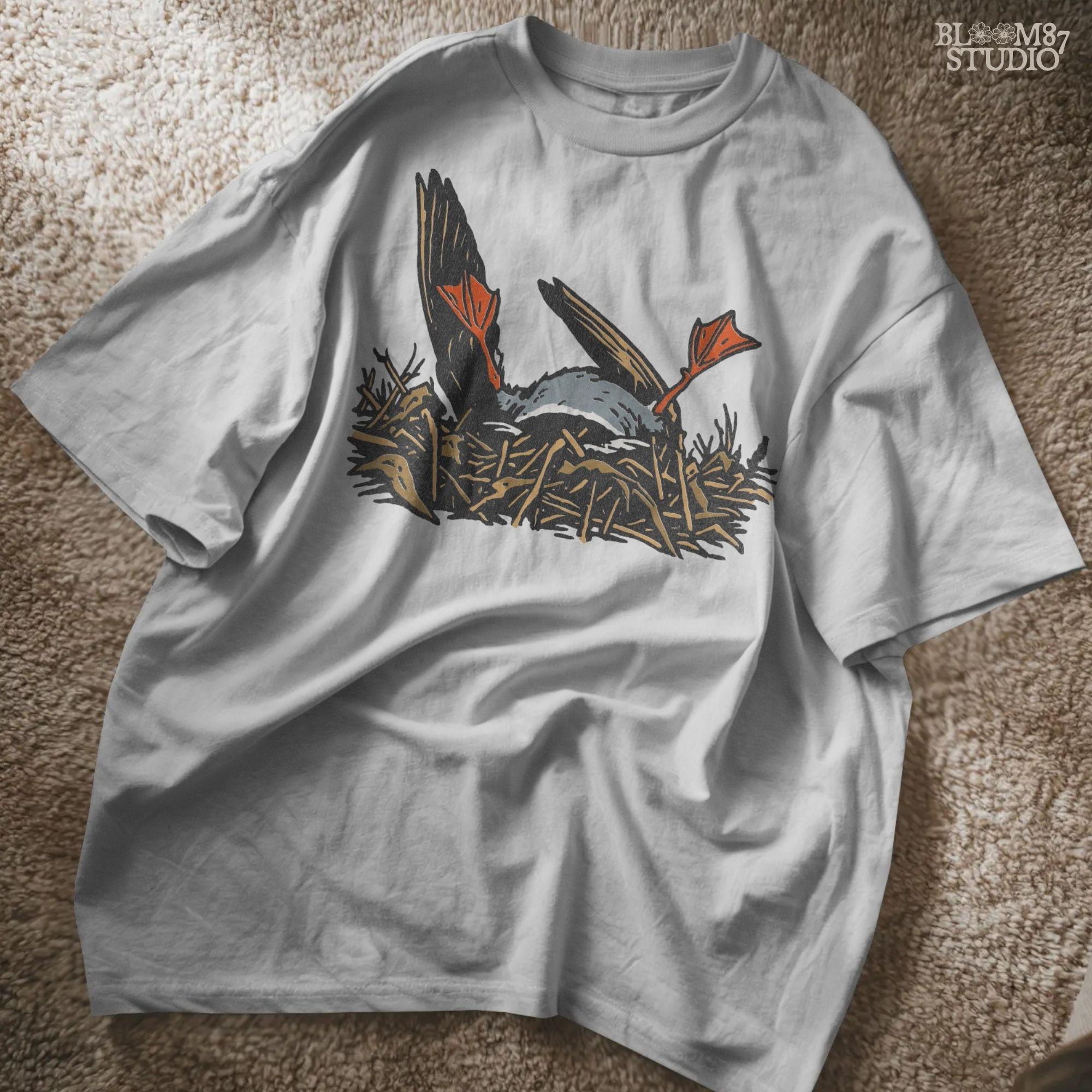 Solid Version:
Cartoon dead duck with orange feet lying in a nest, vintage style sublimation PNG for dark humor Halloween crafts.

Distressed Version:
Distressed-style dead duck illustration in a nest with exaggerated orange feet, ideal for rustic or spooky sublimation designs.