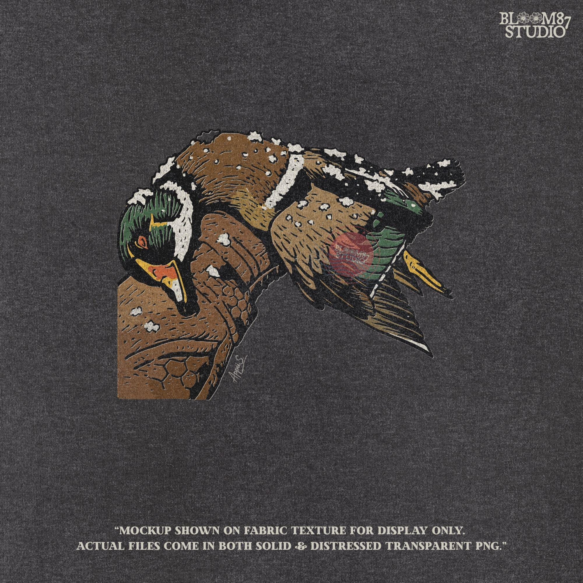 Solid Version:
Realistic illustration of a dead duck lying on a camo arm with snow on its feathers, vintage sublimation PNG for winter hunting themes.

Distressed Version:
Distressed-style snowy duck laying across a hunting jacket, ideal for rustic sublimation and cold season outdoor craft designs.