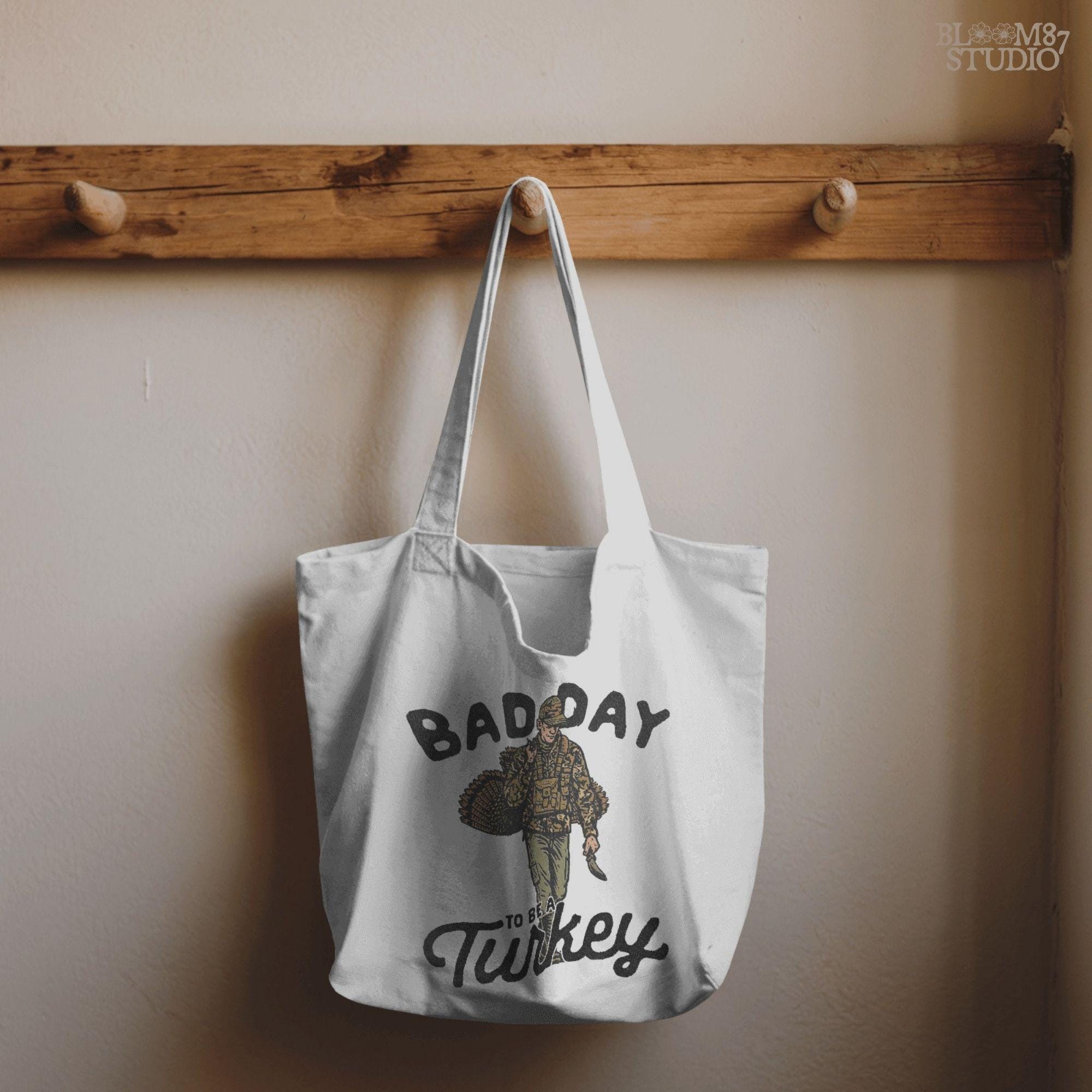 Bold graphic design combining humor and hunting with “Bad Day To Be A Turkey” slogan. Great for making turkey hunting shirts, hunting season mugs, funny Thanksgiving decor, and gifts for hunters.