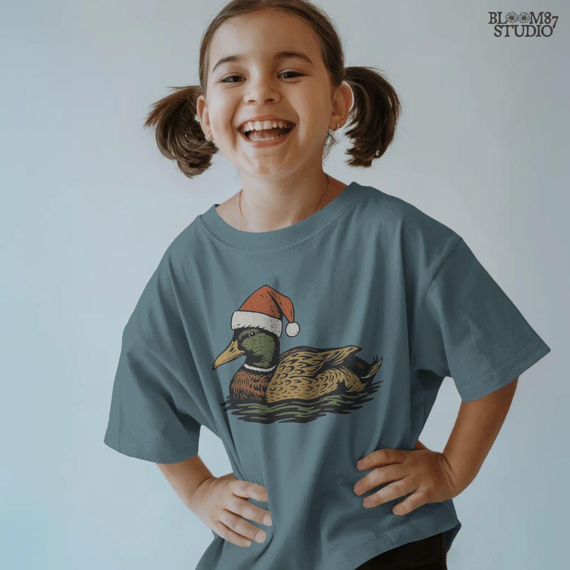 Solid Version:
Vintage illustration of a mallard duck wearing a Santa hat floating on water, sublimation PNG for rustic Christmas crafts and farmhouse holiday decor.

Distressed Version:
Distressed artwork of a festive duck with Santa hat on water, rustic sublimation PNG perfect for farmhouse Christmas shirts, mugs, and seasonal crafts.