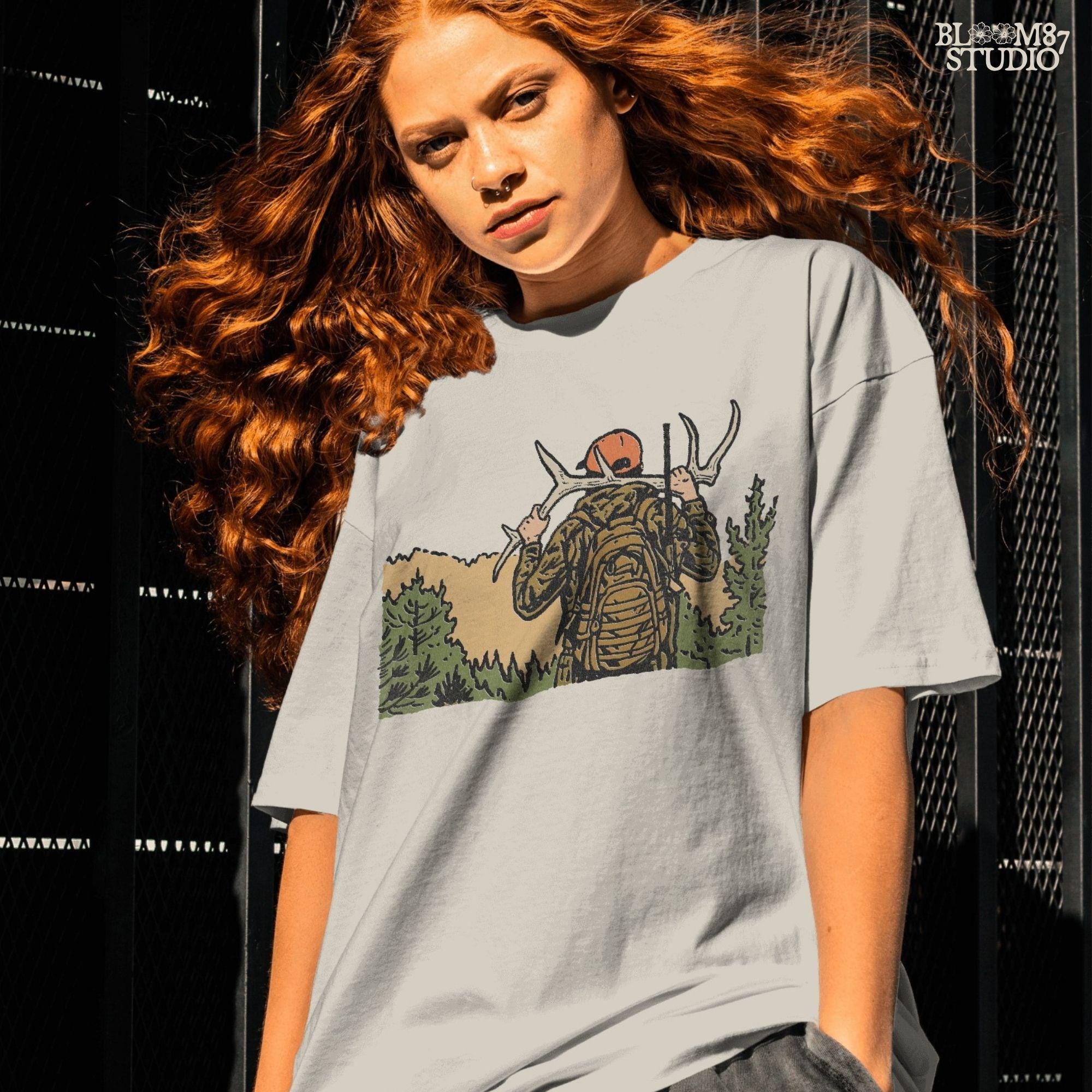 Solid version:
“Hunter carrying deer antlers on shoulders with backpack and rifle in forest – rustic hunting sublimation PNG for outdoor crafts”

Distressed version:
“Vintage distressed hunting sublimation PNG of hunter in camo with backpack and rifle carrying antlers in forest”