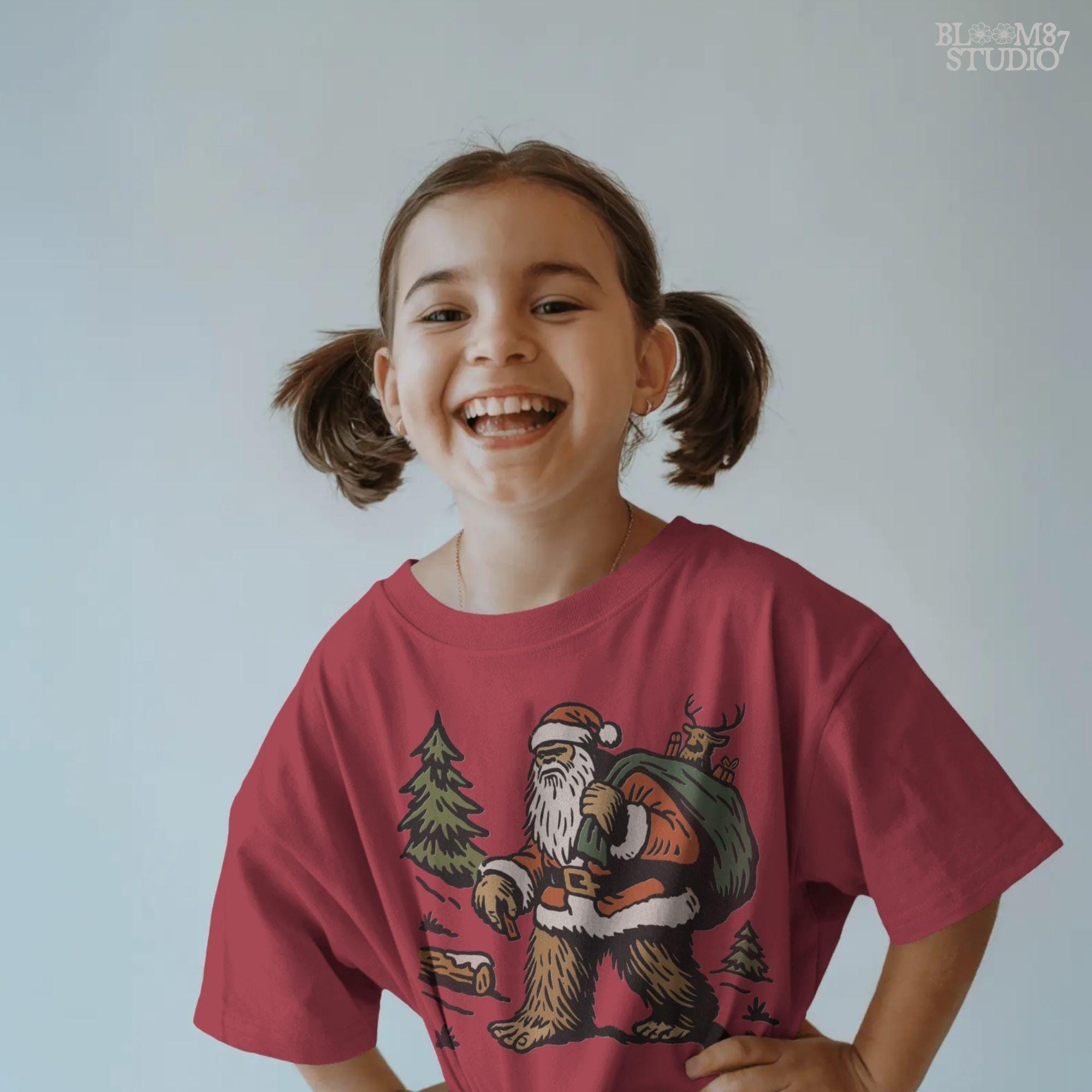 Solid version:
“Bigfoot dressed as Santa carrying green sack with reindeer and gifts in woodland scene – Christmas sublimation PNG for holiday crafts”

Distressed version:
“Vintage distressed sublimation PNG of Santa Bigfoot with sack of gifts and reindeer in rustic woodland scene – Christmas holiday shirt design”