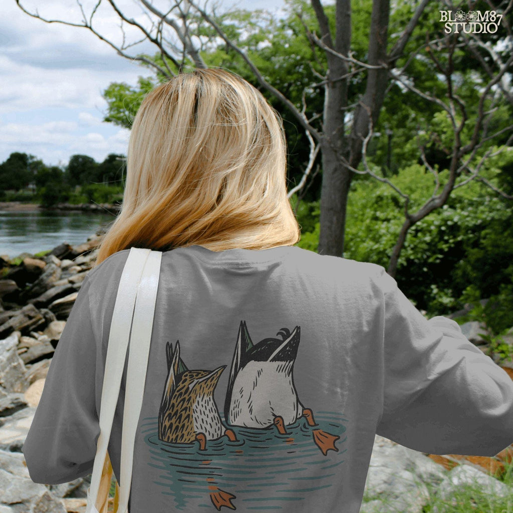Solid version:
“Two ducks dabbling with tails up and feet in water – funny duck sublimation PNG for hunting shirts and rustic crafts”

Distressed version:
“Vintage distressed sublimation PNG of two ducks with tails up in pond – funny waterfowl hunting and rustic outdoor design”