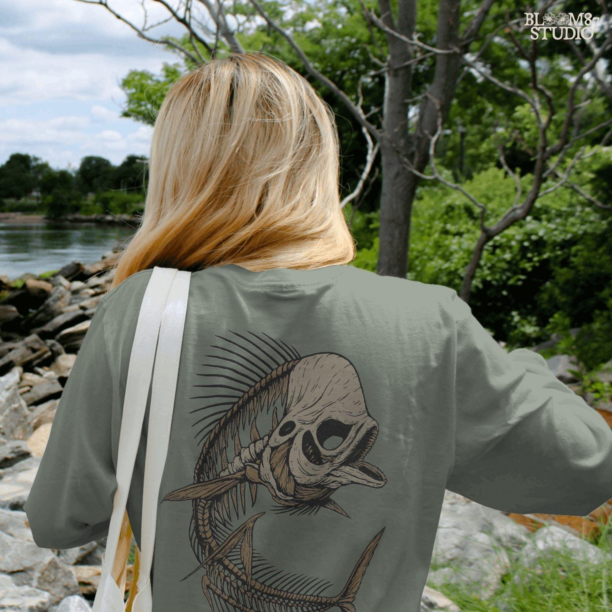 Solid version: Illustration of a spooky fish skeleton with skull head, Halloween creepy PNG design.
Distressed version: Vintage distressed skeleton fish with skull face and spiky bones, gothic Halloween PNG.