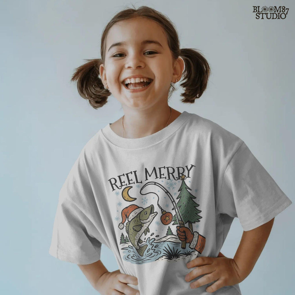 Solid: “Christmas fishing PNG with bass wearing Santa hat jumping near holiday tree, Reel Merry text design for shirts”

Distressed: “Vintage distressed Christmas fishing PNG with bass, Santa hat, holiday tree and Reel Merry festive design”