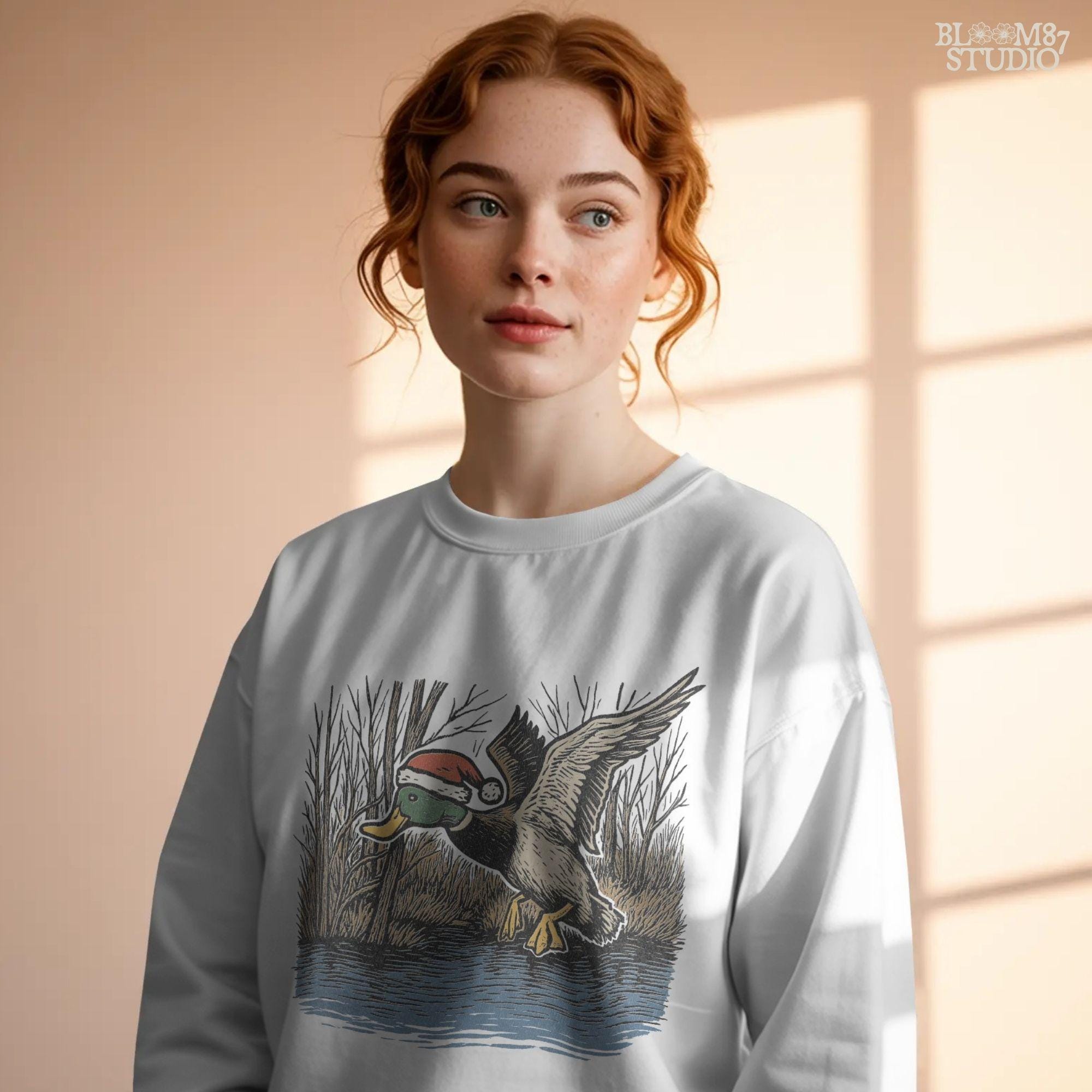 A Christmas hunting PNG design showing a mallard duck in motion with Santa hat, detailed feathers, and winter background. Perfect for mallard duck hunting shirts, farmhouse Christmas art, mugs, and rustic sublimation projects.