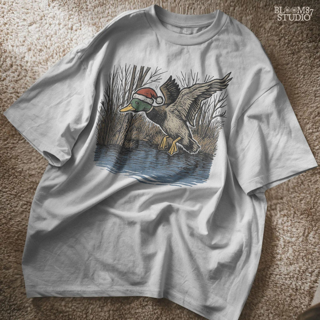 Festive mallard duck hunting design for Christmas crafts. Features a flying mallard duck over water, wearing Santa’s red hat. Ideal sublimation file for shirts, mugs, tumblers, and hunting season holiday decor. Great gift idea for hunters.