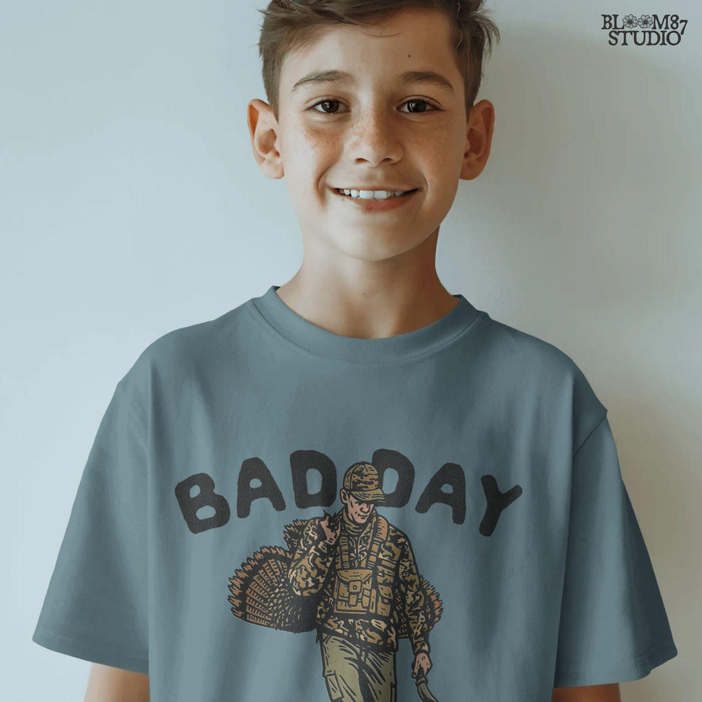 Hunting-themed illustration designed for turkey season projects. Includes a hunter with his catch and the phrase “Bad Day To Be A Turkey.” Ideal for sublimation on shirts, mugs, and Thanksgiving humor gifts.