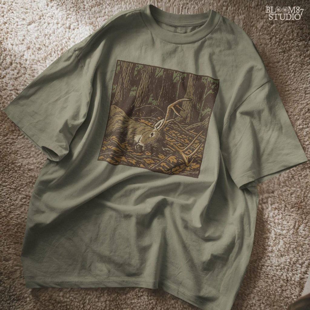 Drawing of a deer buck with antlers lying among fallen leaves in the woods, capturing the mood of hunting season. Ideal for deer hunting sublimation, apparel, mugs, and outdoorsman gifts.
