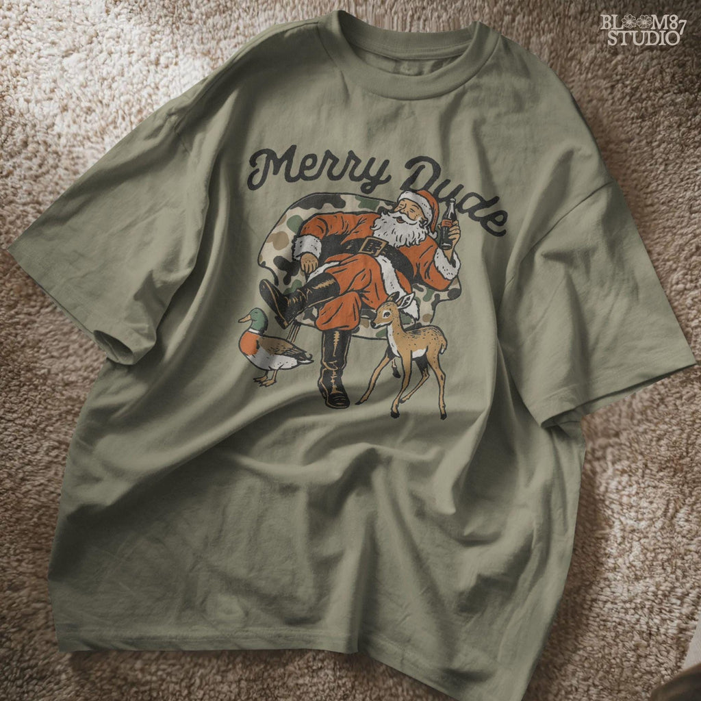 Retro-style Santa Claus with camo chair, cheerful pose, soda in hand, surrounded by festive animals including a deer and duck. Works well for Christmas apparel, Santa hunting gifts, camo holiday crafts, and sublimation printing.