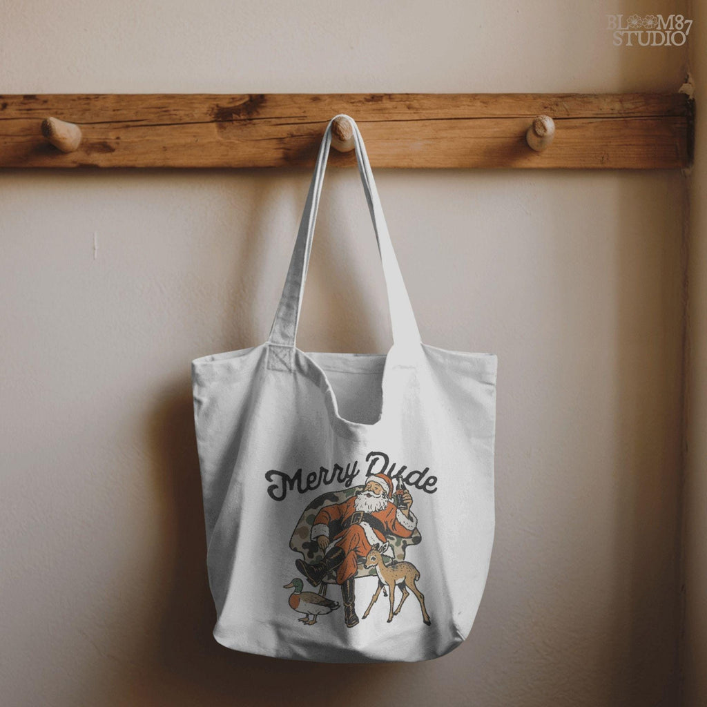 Rustic-style Christmas Santa digital design, Santa seated in camo chair with animals, holding soda bottle, text above. Best for holiday shirt printing, camo Santa clipart, Christmas mugs, and sublimation crafts.